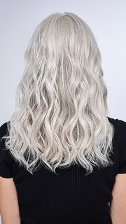Model is wearing 16" AU NATUREL WAVES TOPPER by HAIRDO in color R56/60 SILVER MIST | Lightest Gray with 20% Medium Brown Evenly Blended with Pure White
