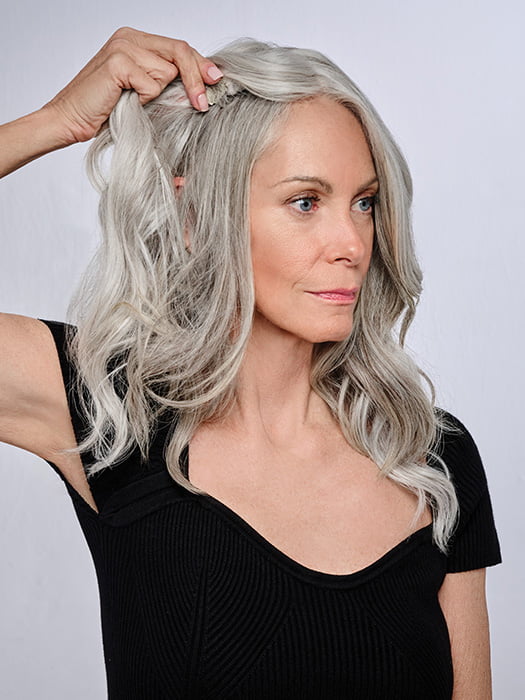 Model is wearing 16" AU NATUREL WAVES TOPPER by HAIRDO in color R56/60 SILVER MIST | Lightest Gray with 20% Medium Brown Evenly Blended with Pure White