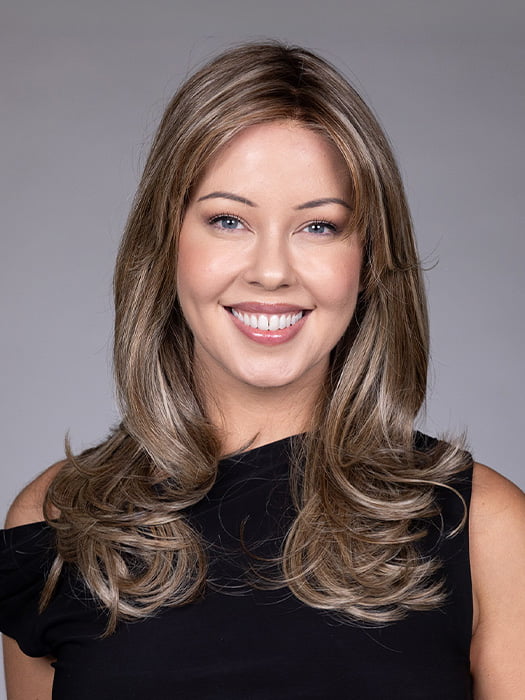 Model is wearing MARSEILLE by BELLETRESS in color MACADAMIA LATTE R | A combination of Medium and Light Brown, highlighted with Light Gold Blonde, and a mixture of Ash Blonde and Light Gold Blonde, Rooted with Medium and Light Brown