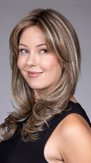 Model is wearing MARSEILLE by BELLETRESS in color MACADAMIA LATTE R | A combination of Medium and Light Brown, highlighted with Light Gold Blonde, and a mixture of Ash Blonde and Light Gold Blonde, Rooted with Medium and Light Brown