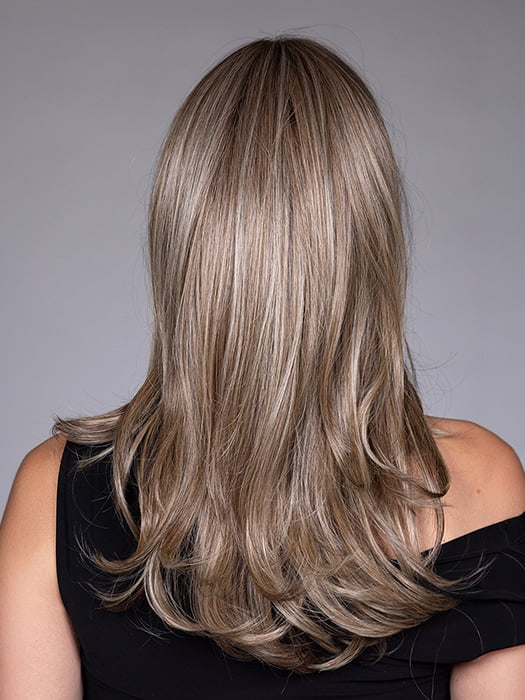 Model is wearing MARSEILLE by BELLETRESS in color MACADAMIA LATTE R | A combination of Medium and Light Brown, highlighted with Light Gold Blonde, and a mixture of Ash Blonde and Light Gold Blonde, Rooted with Medium and Light Brown