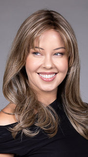 Model is wearing MARSEILLE by BELLETRESS in color MACADAMIA LATTE R | A combination of Medium and Light Brown, highlighted with Light Gold Blonde, and a mixture of Ash Blonde and Light Gold Blonde, Rooted with Medium and Light Brown