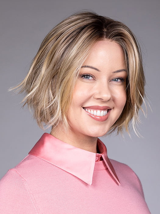 Model is wearing OSLO by BELLETRESS in color RAW SUGAR BLONDE | A Neutral Light Blonde, Honey Blonde, Pale Gold Blonde, with a base of Light Brown Lowlights featuring a Medium Root Color