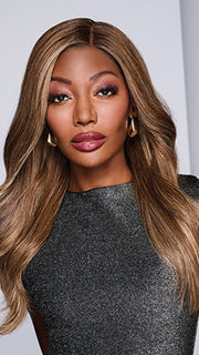 Model is wearing ATHENIAN ADVENTURE by RAQUEL WELCH in color RH9/24SS SHADED CAFE LATTE | Dark Brown with Golden Brown highlights from dark roots to ends