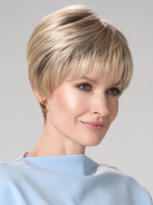 Model is wearing TIFFANY HAND TIED by ENVY in color SILKY BEIGE | Light Platinum Blonde with Dark Brown Roots