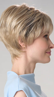 Model is wearing TIFFANY HAND TIED by ENVY in color SILKY BEIGE | Light Platinum Blonde with Dark Brown Roots