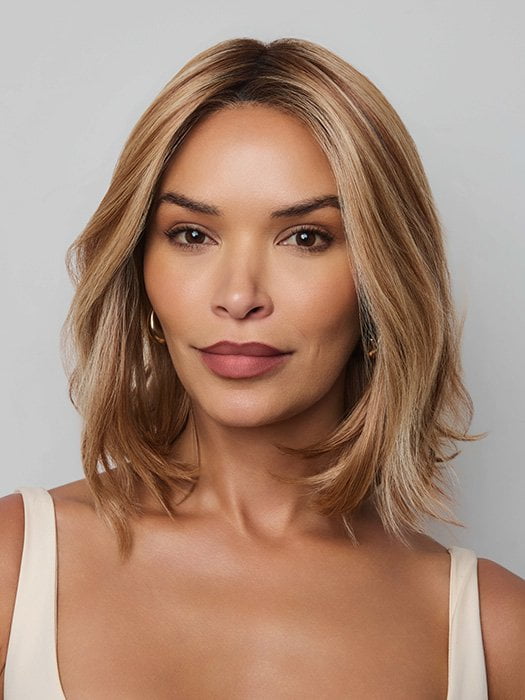 Model is wearing YUI by NORIKO in color GLAZED CARAMEL R | Warm Brown and Dark Blonde Tones with Ashy Highlights and a Dark Root