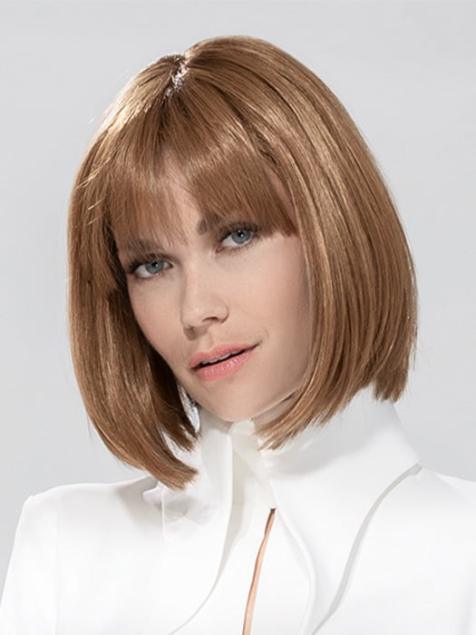 Model is wearing MISS COMFORT by ELLEN WILLE in color ALMOND BROWN ROOTED 830.9 | Medium Brown, Light Auburn and Medium Warm Brown Blend with Shaded Roots