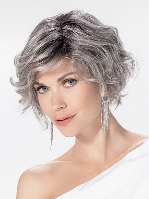 Model is wearing ROMANCE DELUXE by ELLEN WILLE in color METALLIC GREY ROOTED 60.51 | Pearl White, Darkest/Lightest Brown with Grey Blend with Shaded Roots