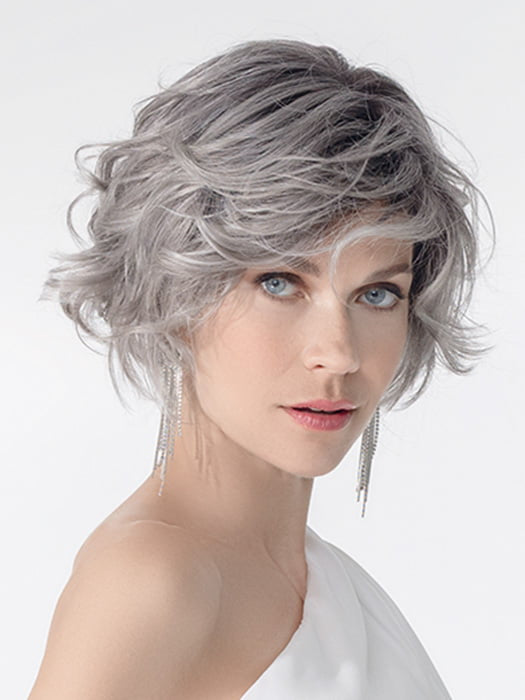 Model is wearing ROMANCE DELUXE by ELLEN WILLE in color METALLIC GREY ROOTED 60.51 | Pearl White, Darkest/Lightest Brown with Grey Blend with Shaded Roots