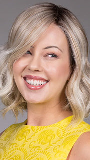 Model is wearing ISSEY in color BUTTER BEER R | A rich blend of warm brunette and golden honey highlights finished with a soft, natural root.