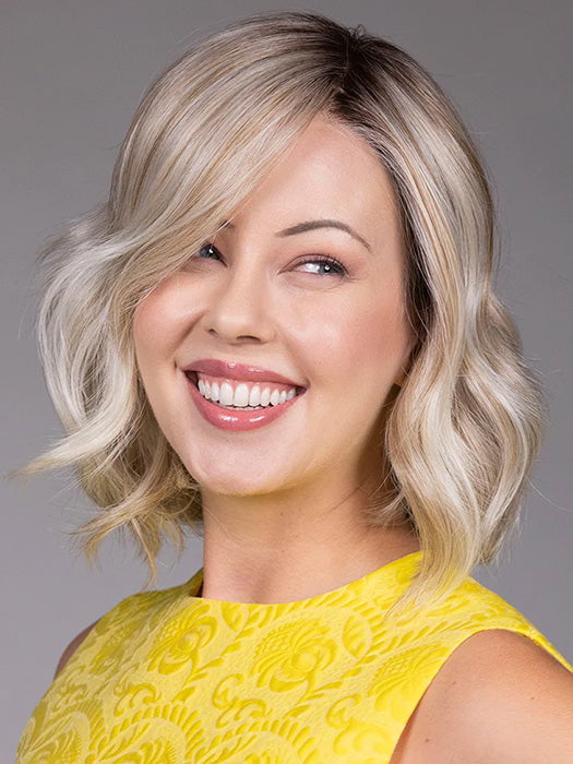 Model is wearing ISSEY in color BUTTER BEER R | A rich blend of warm brunette and golden honey highlights finished with a soft, natural root.