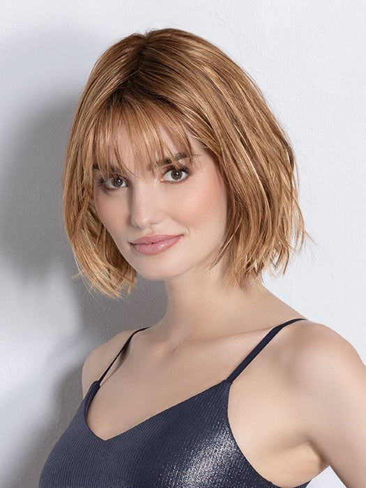 Model is wearing DARK SAND FROSTED | Lightest Brown and Medium Warm Brown with Grey Blend and a Soft Matte Finish